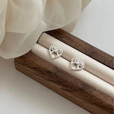 Heart's Whisper · Silver Bow Stud Earrings